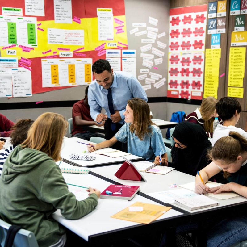 Group of students learning with their teacher